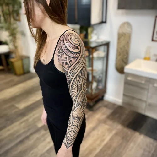 Full-sleeve tattoo on a shoulder and arm of Niho Mano geometric motifs | Downtown Las Vegas