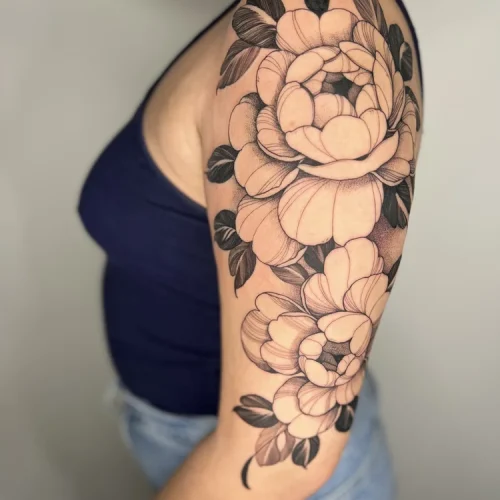 Black and grey tattoo on the upper arm of blooming peonies | Downtown Las Vegas