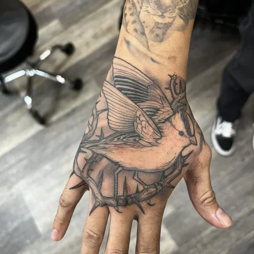 Black and grey hand tattoo featuring a sparrow | Downtown Las Vegas