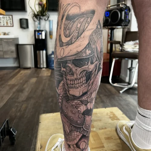 Large black and grey illustrative leg tattoo of a skeleton | Las Vegas Arts District