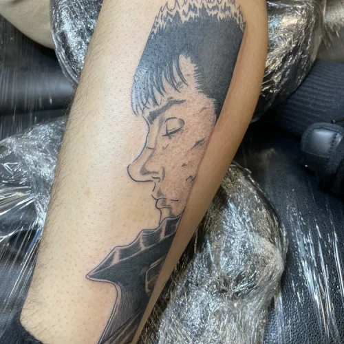 black and grey profile tattoo of Guts from Berserk Las Vegas - By Baby G 18b Tattoo
