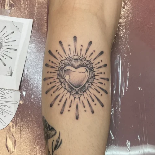 Heart tattoo with a sunburst of radiant lines | Las Vegas Arts District
